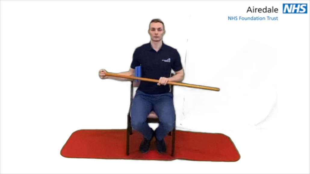 Seated shoulder external rotation with stick