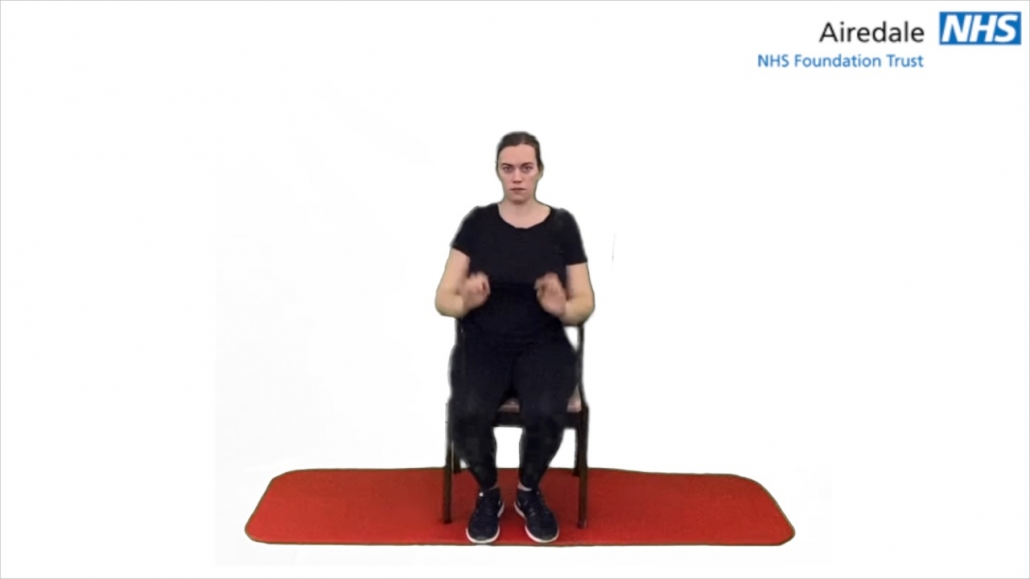 Seated trunk twist hands on head